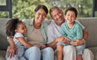 © Alex S/peopleimages.com - Love, happy family and children bonding with grandparents on sofa at home, laugh and having fun in their family home. Relax, play and excited kids embracing and enjoying a visit to grandparent home