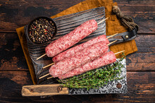 Fresh Raw Kofta Or Lula Kebabs Skewers On Wooden Board With Thyme. Wooden Background. Top View