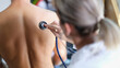 © megaflopp - Young doctor examines the patient lungs with stethoscope