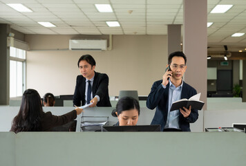 businessman in dark blue suit with eyeglasses making a call on mobile phone and checking information