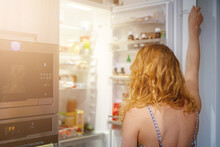 Woman In Front Of The Refrigerator.