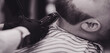© jozzeppe777 - Barber cuts a man's beard