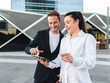 © Westend61 - Cheerful businesswoman with colleague using tablet PC standing at office park