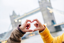 London, United Kingdom, Couple Making Heart-shaped Finger Frame