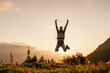 © Westend61 - Happy man jumping on top of mountain at sunset