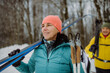 © Halfpoint - Happy senior woman preparing for winter skiing with her husband.