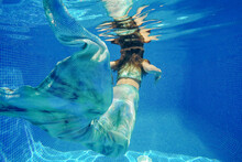 Girl In Mermaid Costume Swimming Underwater