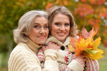 Wall Mural - Portrait of an elderly woman with her daughter in autumn.