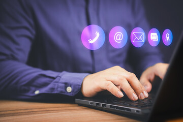 Businessman using a computer laptop with the call phone, email, address, chat message and map icons. Customer support hotline contact us people connection concept.