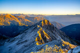 Fototapeta Mapy - Alpine mountain peaks illuminated by rising sun