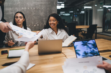 Wall Mural - Diverse women sitting at table during meeting in office