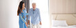 Portrait of Asian young nurse helping old elderly disable man grandfather to walk by using walker equipment in the bedroom. Senior patient of nursing home moving with walking frame and nurse support