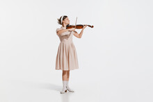 Charming Beautiful Young Girl Playing Violin Isolated Over White Studio Background. Tender, Lovely Sound. Concept Of Retro, Vintage Style