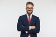 happy businessman with glasses crossing arms, smiling and posing