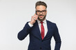 portrait of sexy bearded man with glasses talking on the phone