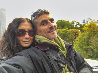 Wall Mural - Happy couple taking selfies in the city park, foliage season