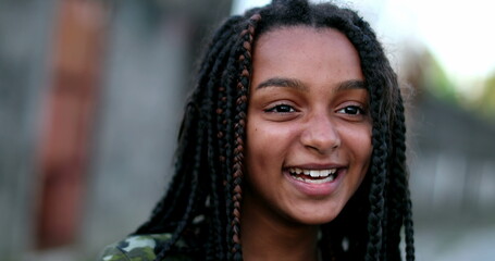 Wall Mural - Black preteen girl laughing and smiling portrait face. Real life laugh and smile