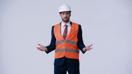 Poster - confused foreman in formal wear and protective equipment showing shrug gesture isolated on grey.