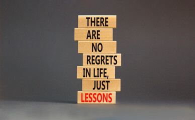Wall Mural - Regrets or lessons symbol. Concept words There are no regrets in life just lessons on wooden blocks on a beautiful grey table grey background. Business regrets or lessons concept. Copy space