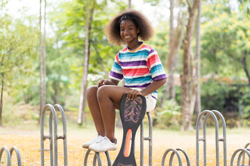 Wall Mural - Portrait of two African American child girl smiling with skateboard at the playground