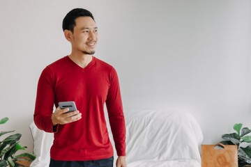 Happy smile face asian man use smartphone for trading and business application.