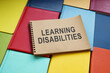 © Vitalii Vodolazskyi - Learning disabilities sign in the notepad and books.