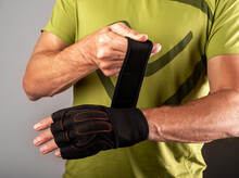 Wrapping, Putting On Training Workout Gloves On Hands For Wrist Protection. Photo