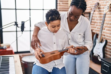 Poster - African american mother and son student learning play ukelele at music studio