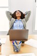 © Krakenimages.com - Young latin woman smiling confident relaxed with hands on head at office