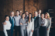 © deagreez - Portrait of group successful positive people hug standing together building indoors