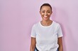 © Krakenimages.com - Beautiful african american woman standing over pink background with a happy and cool smile on face. lucky person.