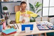 © Krakenimages.com - African american woman artist drawing on notebook having video call at art studio