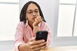 © Krakenimages.com - Young african american woman using smartphone working at office