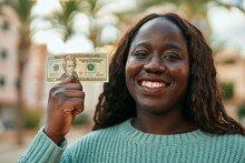 Young African Woman Smiling Happy Holding 20 Dollar Banknote At The City