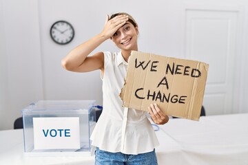 Sticker - Young blonde woman at political election holding we need a change banner stressed and frustrated with hand on head, surprised and angry face