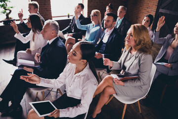 Wall Mural - Photo of crowd business people sitting chair conference room raise arm ask question building indoors