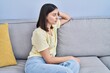 © Krakenimages.com - Young hispanic woman stressed sitting on sofa at home
