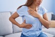 © Krakenimages.com - Young woman examining breast with hands at home