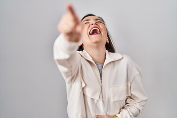 Wall Mural - Middle age hispanic woman standing over isolated background laughing at you, pointing finger to the camera with hand over body, shame expression