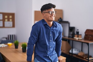 Wall Mural - Young hispanic man business worker smiling confident at office