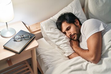 Sticker - Young hispanic man lying on bed sleeping at bedroom