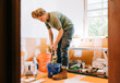 a young female craftsman works on a bathroom remodel