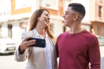 Sticker - Man and woman mother and son smiling confident make selfie by the smartphone at street