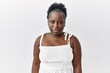 © Krakenimages.com - Young african woman standing over white isolated background relaxed with serious expression on face. simple and natural looking at the camera.