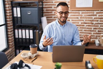 Young hispanic man business worker having video call working at office