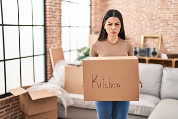 Poster - Young woman moving to a new home holding box depressed and worry for distress, crying angry and afraid. sad expression.