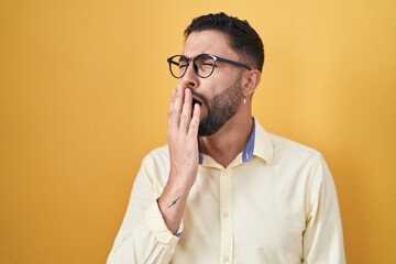 Canvas Print - Hispanic young man wearing business clothes and glasses bored yawning tired covering mouth with hand. restless and sleepiness.