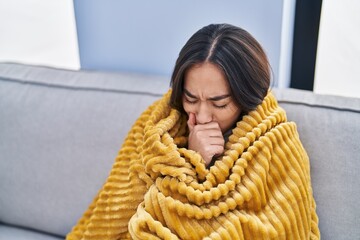 Sticker - Young hispanic woman ill sitting on sofa at home