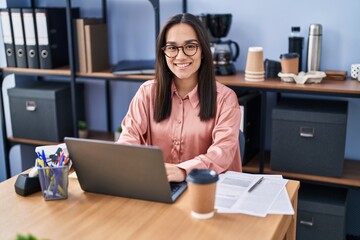 Young hispanic woman business worker using laptop working at office