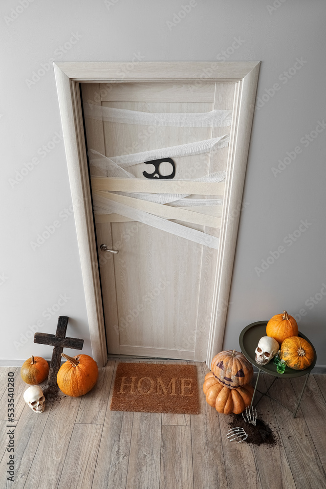 Interior of light hall decorated for Halloween with door and table